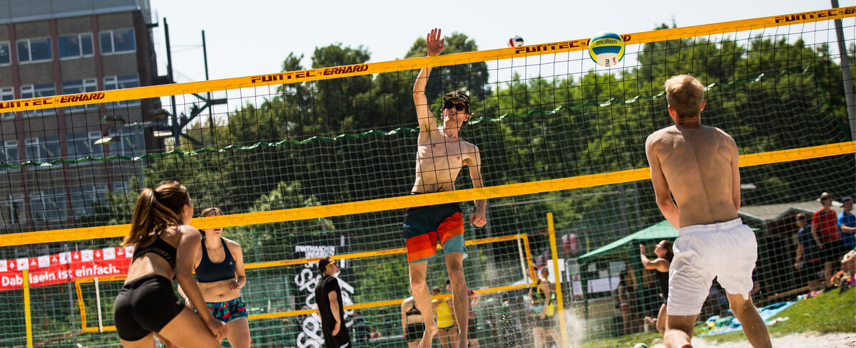 Beach volleyball player about to hit the ball
