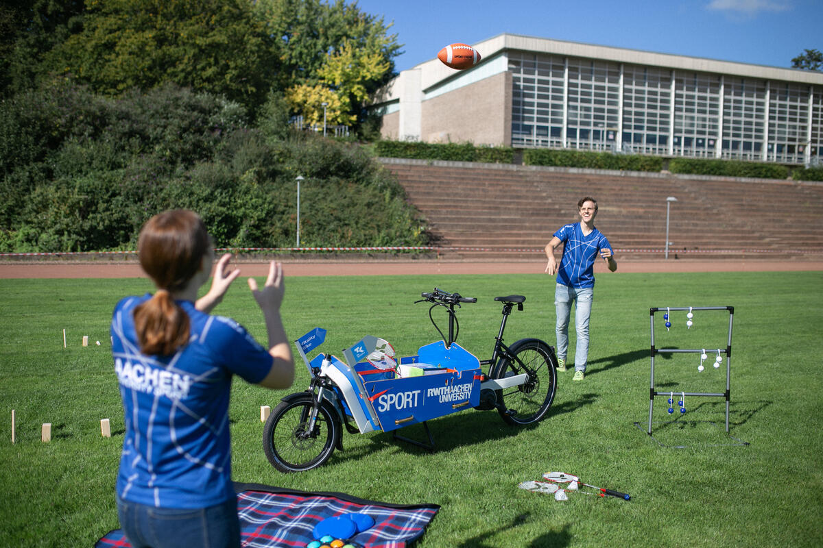 instructors throwing a football at each other