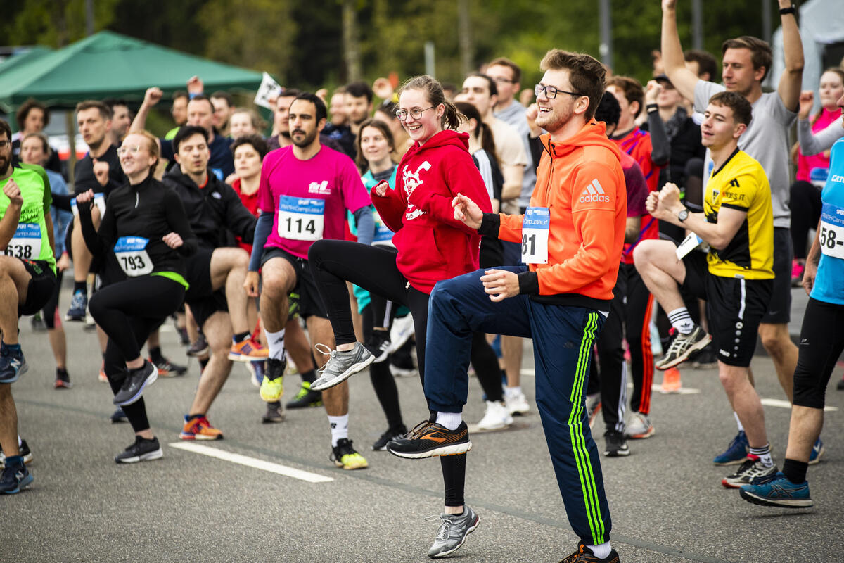 Personen beim Warm-Up vor dem Campuslauf